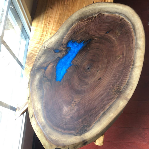 Circular walnut board with blue epoxy